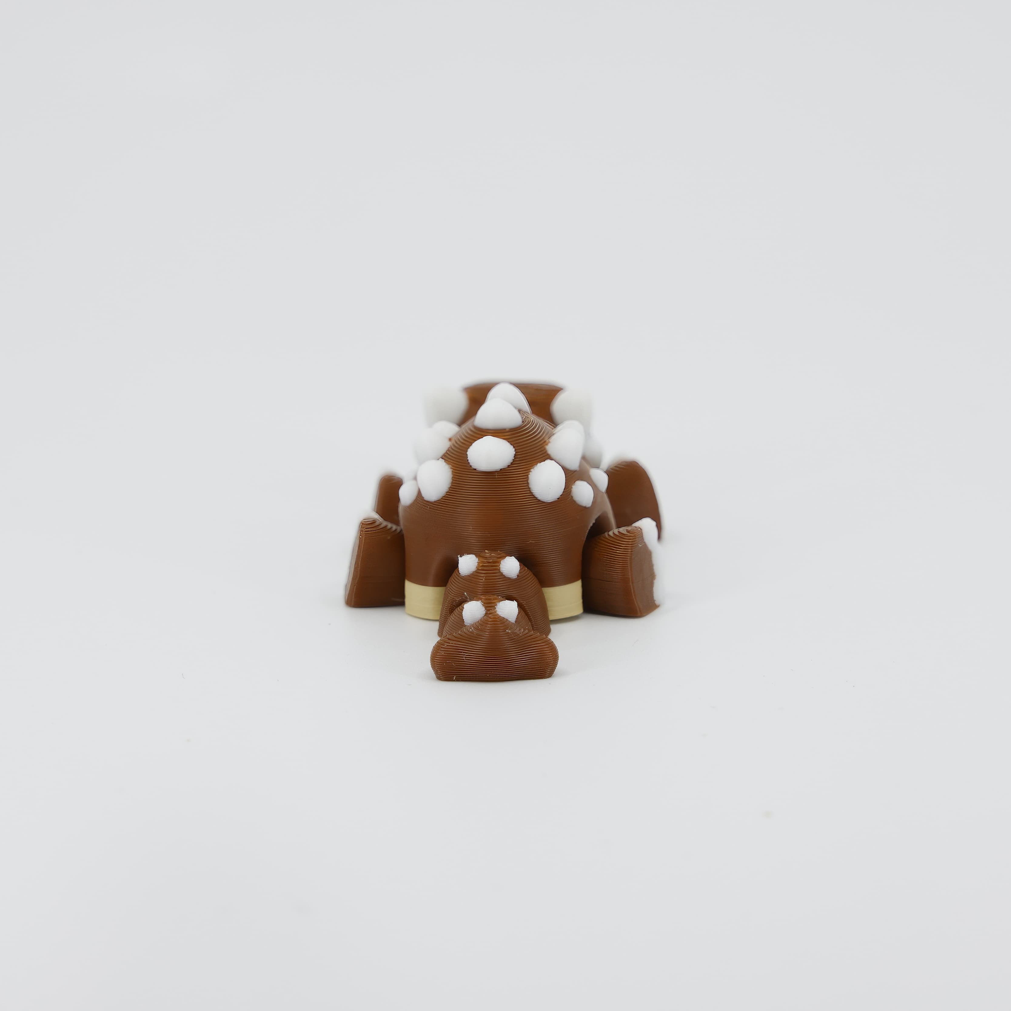 Back detail of the sensory 3D printed mini Ankylosaurus, emphasizing the tail club and textured back designed for fidget play.