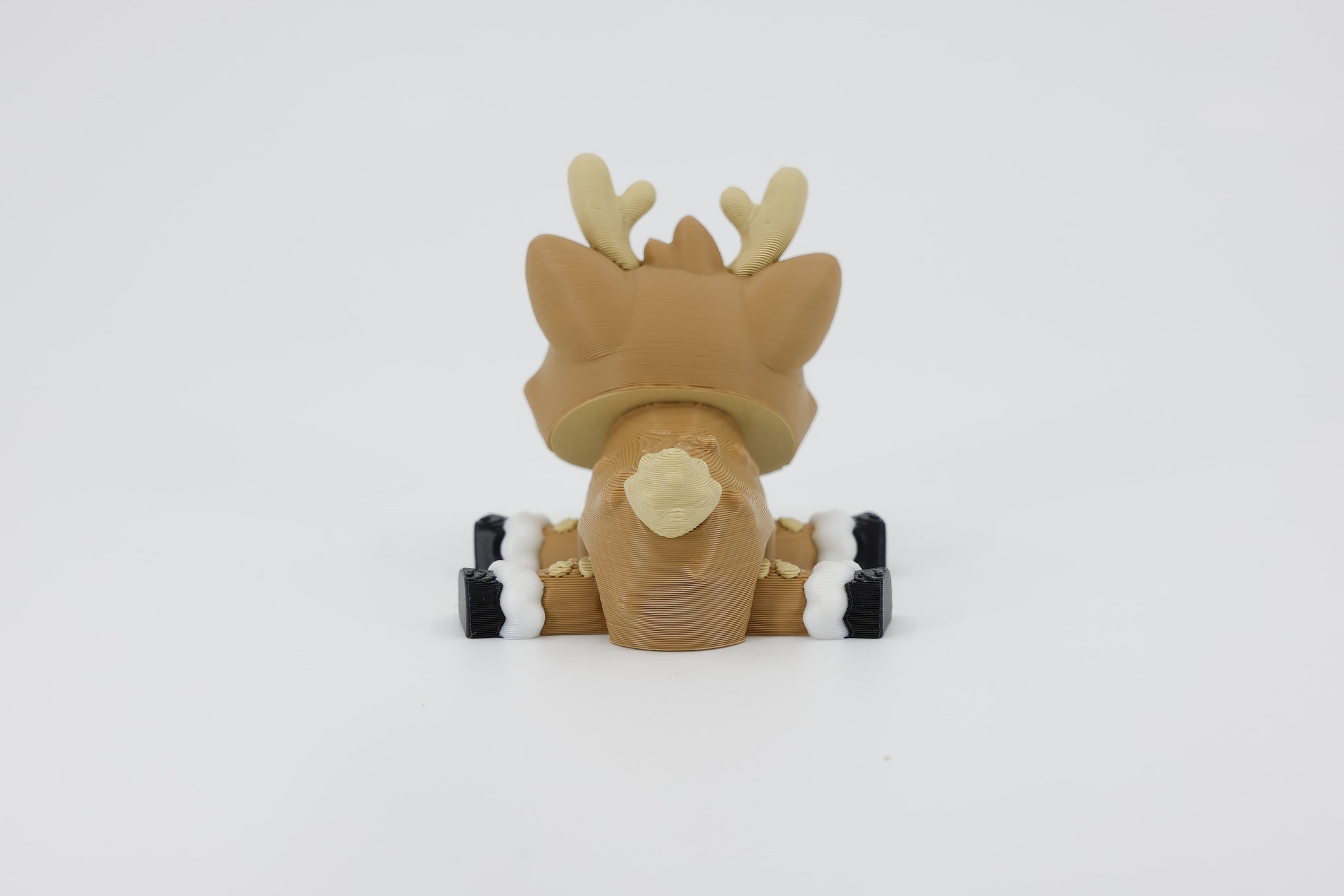Back detail of the sensory 3D printed mini reindeer, emphasizing the smooth texture and small tail designed for fidget play.