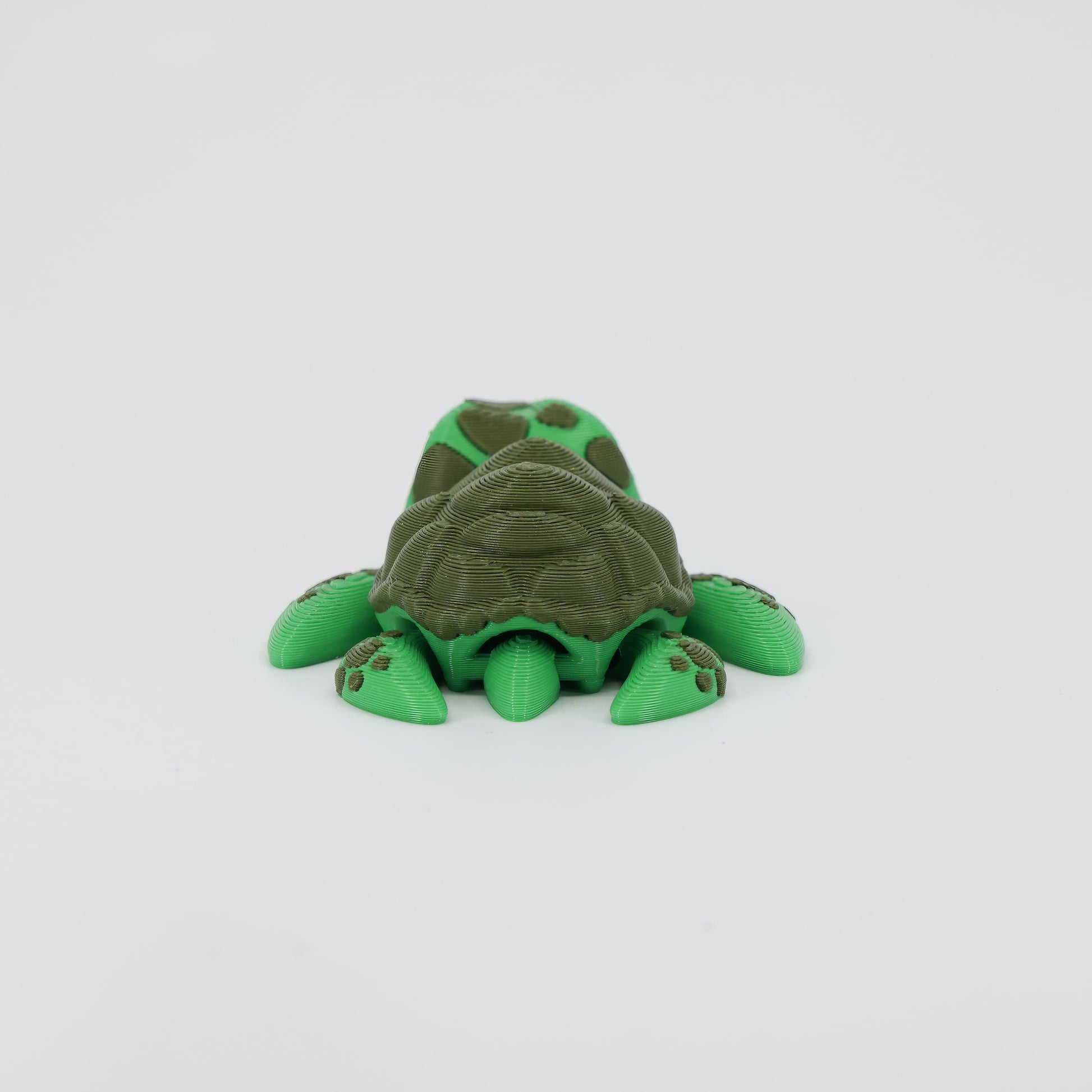 Back detail of the sensory 3D printed mini sea turtle, emphasizing the textured shell pattern designed for tactile fidget play.