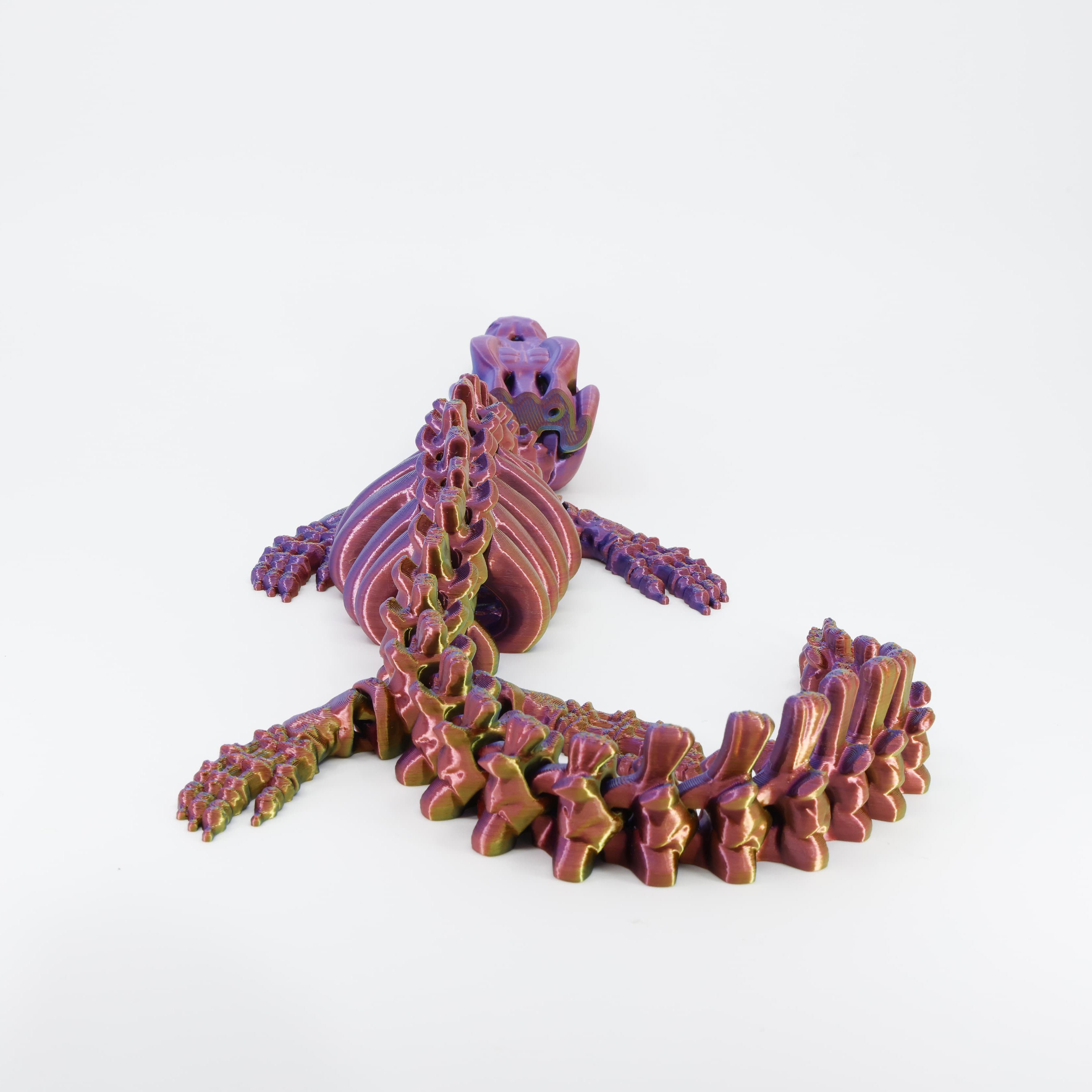 Back detail of the sensory 3D printed dinosaur skeleton, clearly showing the long segmented tail designed for full fidget action.