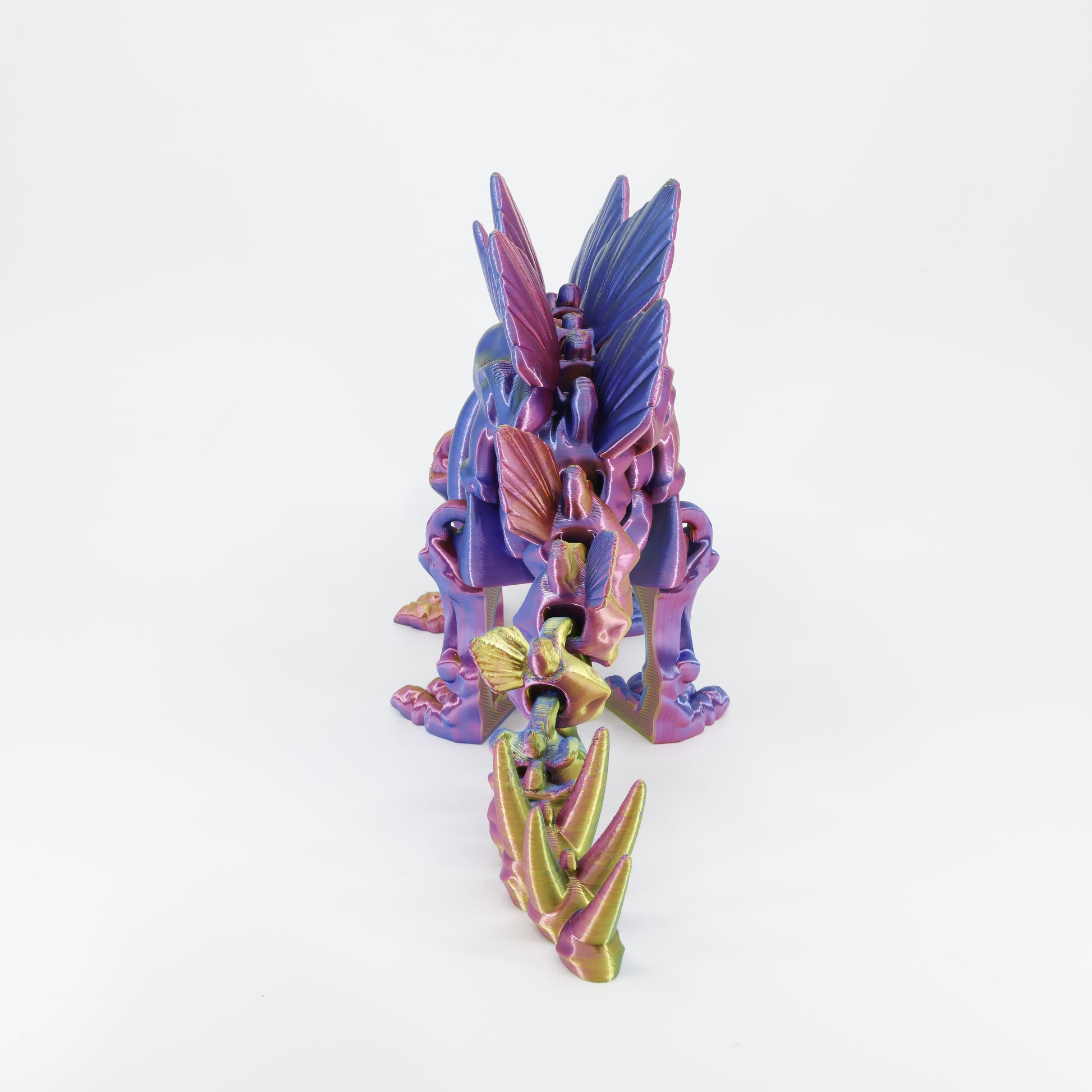 Back detail of the sensory 3D printed dinosaur skeleton, clearly showing the four tail spikes designed for full fidget action.