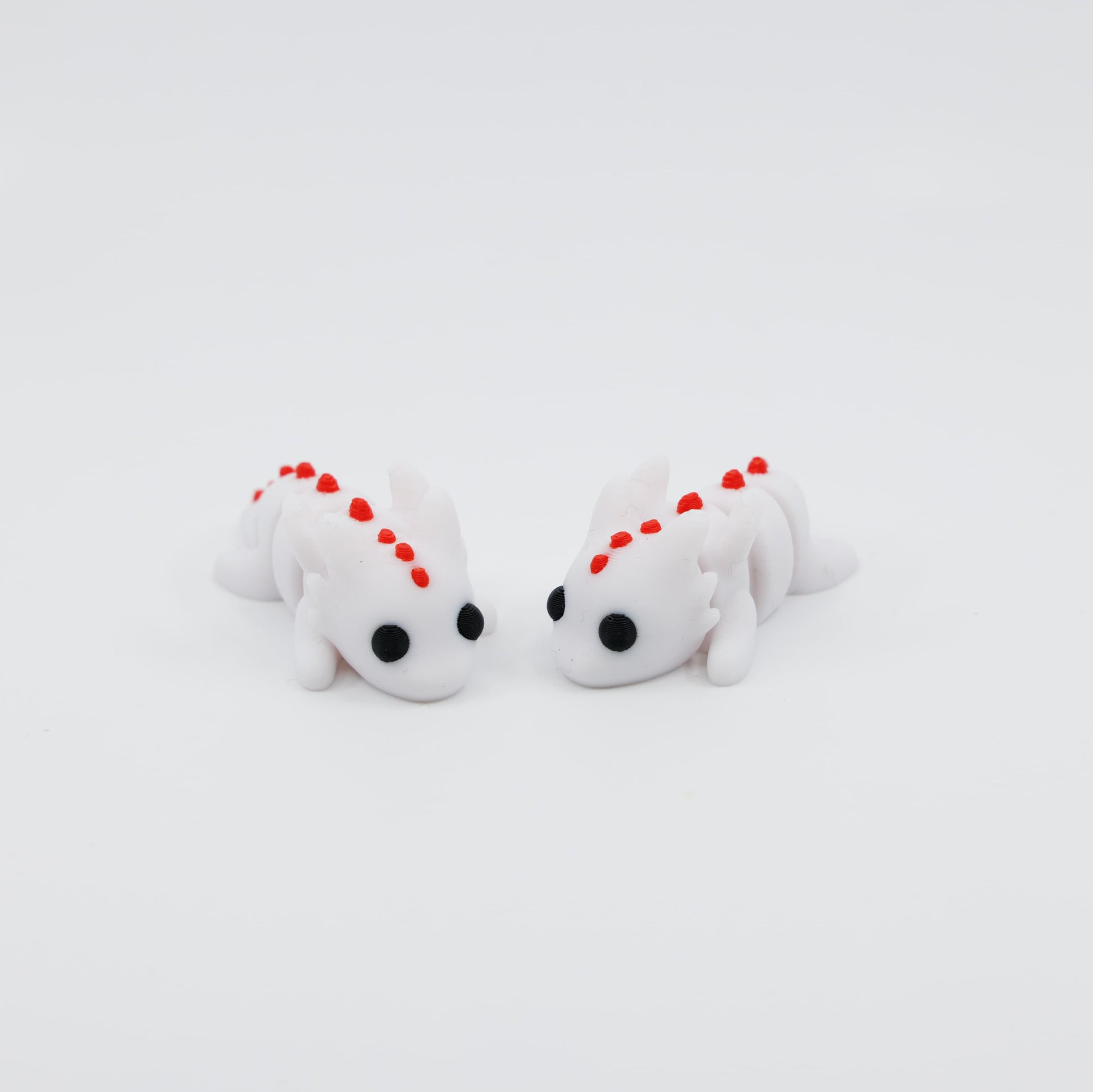 Group of mini dragon fidgets in different poses and colours