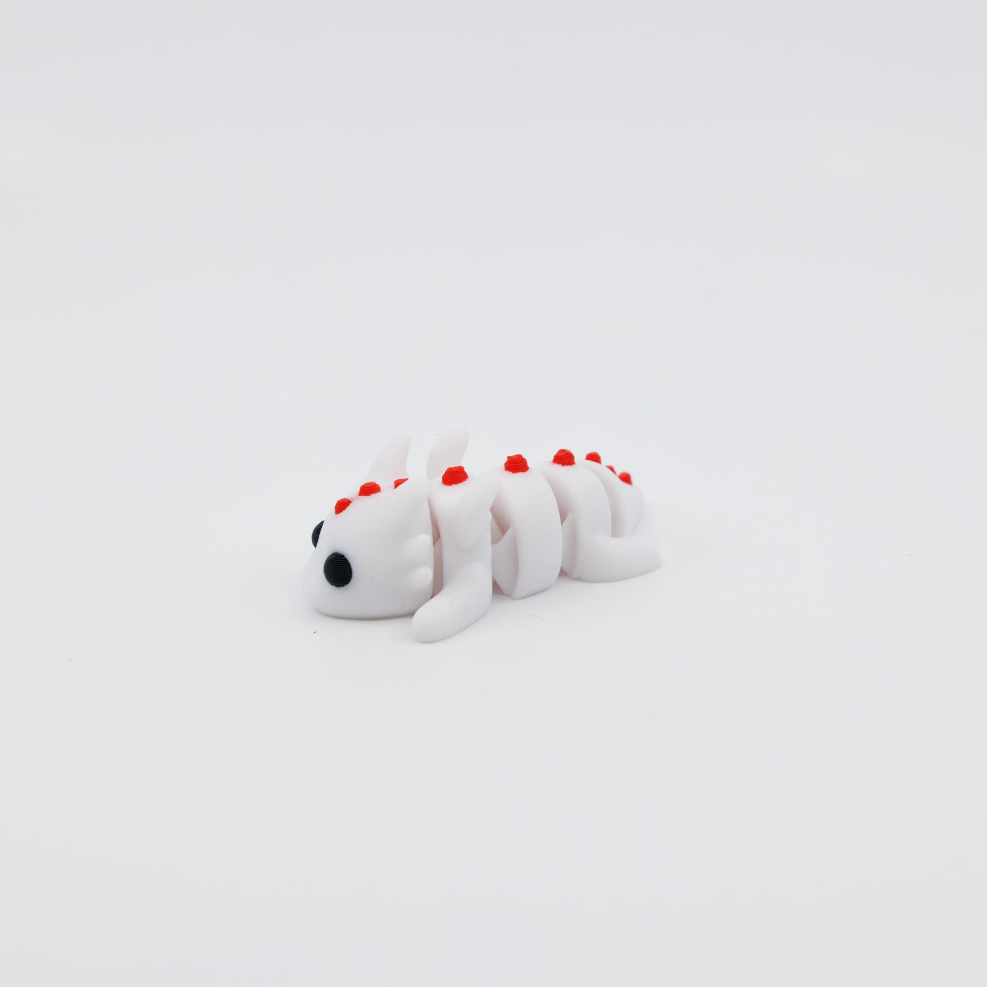 Side view of articulated mini dragon fidget toy