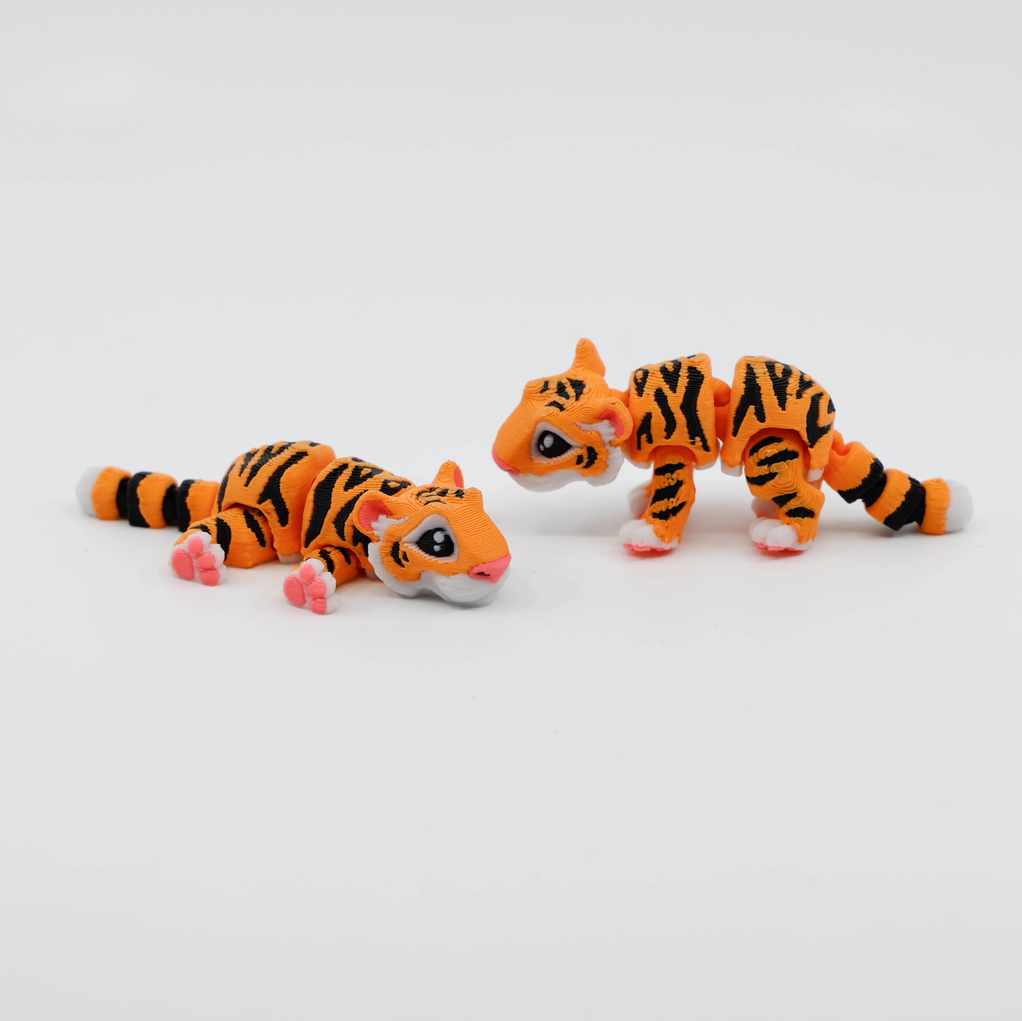 Multiple mini tiger fidgets in different poses and colours